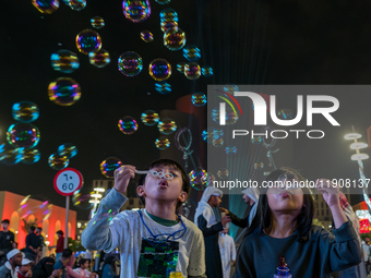 Children blow bubbles at Lusail Boulevard during the 2025 New Year's Day celebrations in Doha, Qatar, on January 1, 2025. (