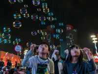 Children blow bubbles at Lusail Boulevard during the 2025 New Year's Day celebrations in Doha, Qatar, on January 1, 2025. (