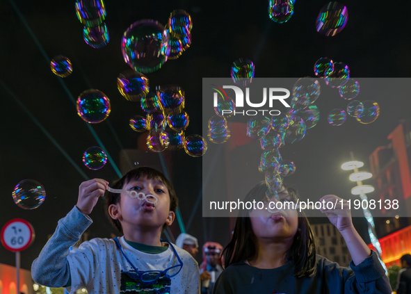 Children blow bubbles at Lusail Boulevard during the 2025 New Year's Day celebrations in Doha, Qatar, on January 1, 2025. 