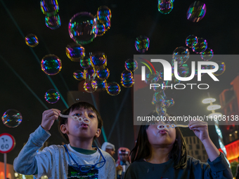 Children blow bubbles at Lusail Boulevard during the 2025 New Year's Day celebrations in Doha, Qatar, on January 1, 2025. (