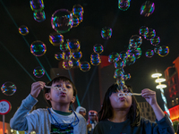 Children blow bubbles at Lusail Boulevard during the 2025 New Year's Day celebrations in Doha, Qatar, on January 1, 2025. (