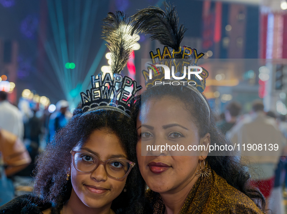 Women wear New Year headbands during New Year's Day celebrations at Lusail Boulevard in Doha, Qatar, on January 1, 2025. 