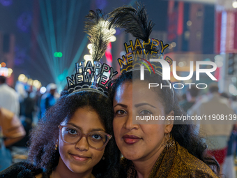 Women wear New Year headbands during New Year's Day celebrations at Lusail Boulevard in Doha, Qatar, on January 1, 2025. (