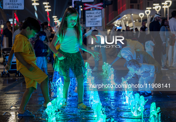 Children play in the water during New Year's Day celebrations at Lusail Boulevard in Doha, Qatar, on January 1, 2025. 