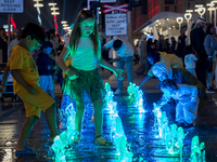 Children play in the water during New Year's Day celebrations at Lusail Boulevard in Doha, Qatar, on January 1, 2025. (