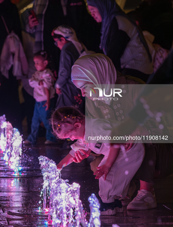 Children play in the water during New Year's Day celebrations at Lusail Boulevard in Doha, Qatar, on January 1, 2025. 