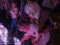 Children play in the water during New Year's Day celebrations at Lusail Boulevard in Doha, Qatar, on January 1, 2025. (