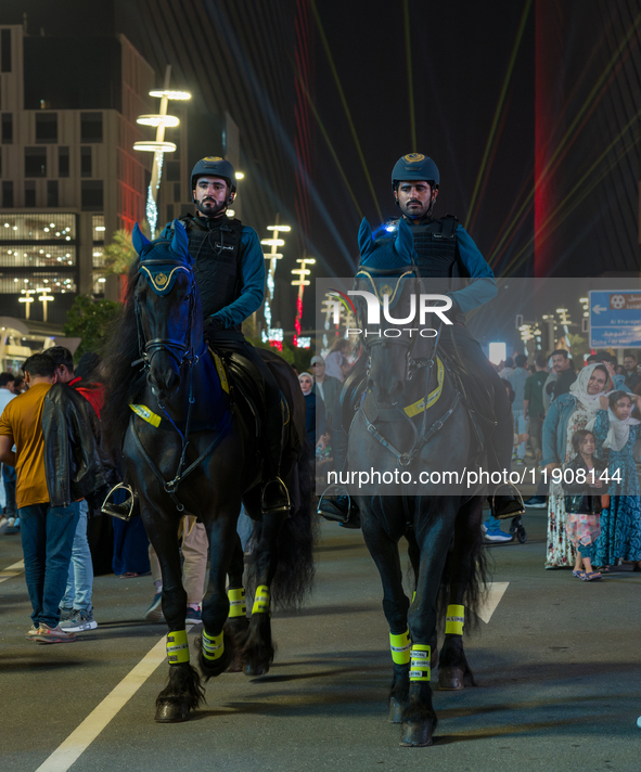 Police on horses patrol as people gather for 2025 New Year's Day celebrations at Lusail Boulevard in Doha, Qatar, on January 1, 2025. 