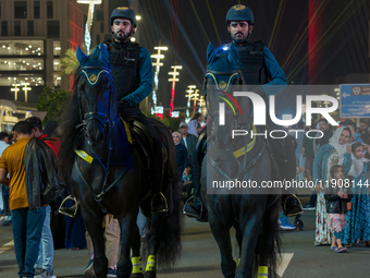 Police on horses patrol as people gather for 2025 New Year's Day celebrations at Lusail Boulevard in Doha, Qatar, on January 1, 2025. (