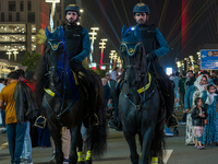 Police on horses patrol as people gather for 2025 New Year's Day celebrations at Lusail Boulevard in Doha, Qatar, on January 1, 2025. (