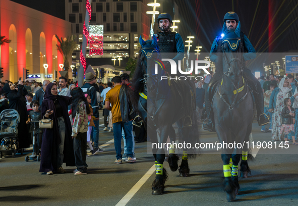 Police on horses patrol as people gather for 2025 New Year's Day celebrations at Lusail Boulevard in Doha, Qatar, on January 1, 2025. 