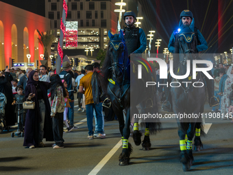 Police on horses patrol as people gather for 2025 New Year's Day celebrations at Lusail Boulevard in Doha, Qatar, on January 1, 2025. (