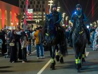 Police on horses patrol as people gather for 2025 New Year's Day celebrations at Lusail Boulevard in Doha, Qatar, on January 1, 2025. (