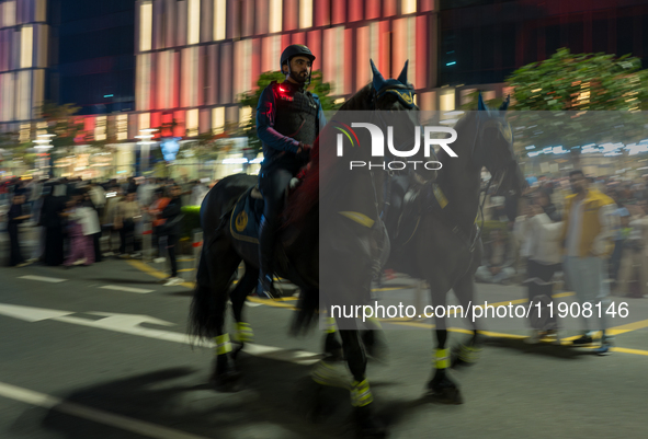 Police on horses patrol as people gather for 2025 New Year's Day celebrations at Lusail Boulevard in Doha, Qatar, on January 1, 2025. 