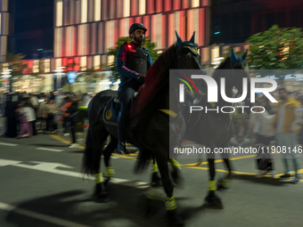 Police on horses patrol as people gather for 2025 New Year's Day celebrations at Lusail Boulevard in Doha, Qatar, on January 1, 2025. (