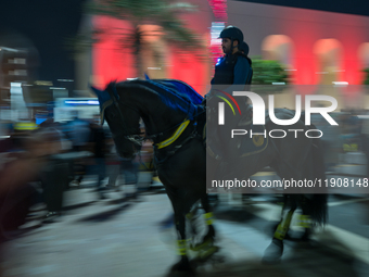 Police on horses patrol as people gather for 2025 New Year's Day celebrations at Lusail Boulevard in Doha, Qatar, on January 1, 2025. (