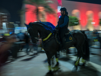 Police on horses patrol as people gather for 2025 New Year's Day celebrations at Lusail Boulevard in Doha, Qatar, on January 1, 2025. (