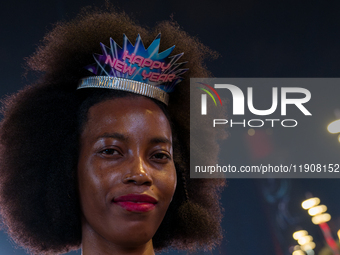 A woman wears a New Year's headband during New Year's Day celebrations at Lusail Boulevard in Doha, Qatar, on January 1, 2025. (