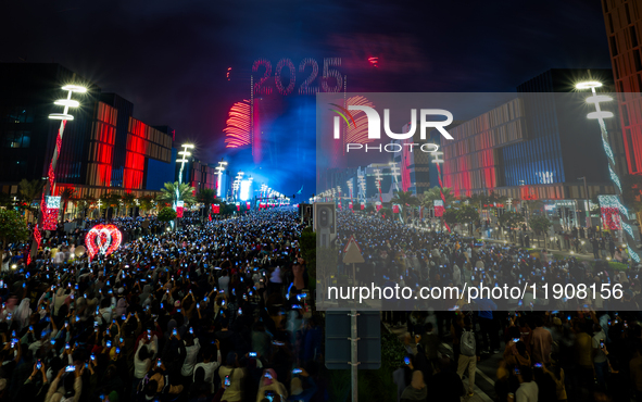 Fireworks and a drone show light up the midnight sky over Lusail Boulevard during the 2025 New Year's Day celebrations in Doha, Qatar, on Ja...