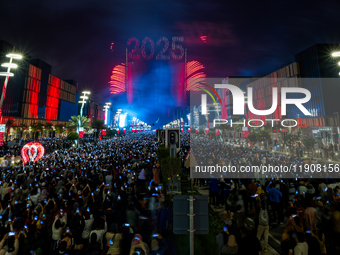 Fireworks and a drone show light up the midnight sky over Lusail Boulevard during the 2025 New Year's Day celebrations in Doha, Qatar, on Ja...