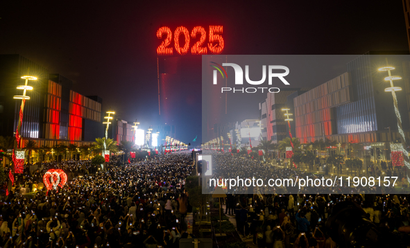 Fireworks and a drone show light up the midnight sky over Lusail Boulevard during the 2025 New Year's Day celebrations in Doha, Qatar, on Ja...