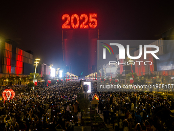 Fireworks and a drone show light up the midnight sky over Lusail Boulevard during the 2025 New Year's Day celebrations in Doha, Qatar, on Ja...