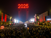 Fireworks and a drone show light up the midnight sky over Lusail Boulevard during the 2025 New Year's Day celebrations in Doha, Qatar, on Ja...