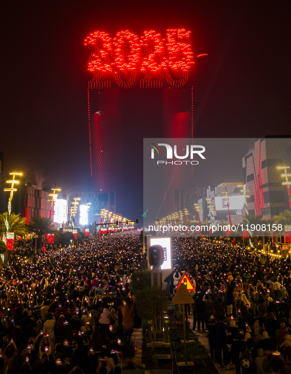 Fireworks and a drone show light up the midnight sky over Lusail Boulevard during the 2025 New Year's Day celebrations in Doha, Qatar, on Ja...