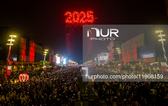 Fireworks and a drone show light up the midnight sky over Lusail Boulevard during the 2025 New Year's Day celebrations in Doha, Qatar, on Ja...