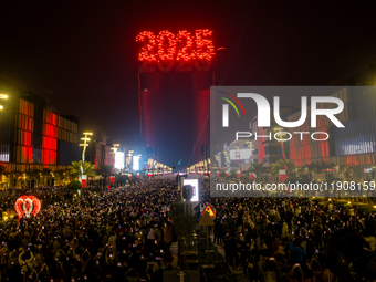 Fireworks and a drone show light up the midnight sky over Lusail Boulevard during the 2025 New Year's Day celebrations in Doha, Qatar, on Ja...