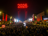 Fireworks and a drone show light up the midnight sky over Lusail Boulevard during the 2025 New Year's Day celebrations in Doha, Qatar, on Ja...