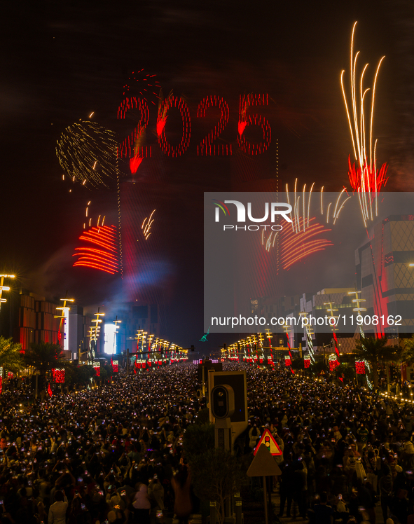 Fireworks and a drone show light up the midnight sky over Lusail Boulevard during the 2025 New Year's Day celebrations in Doha, Qatar, on Ja...