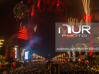 Fireworks and a drone show light up the midnight sky over Lusail Boulevard during the 2025 New Year's Day celebrations in Doha, Qatar, on Ja...