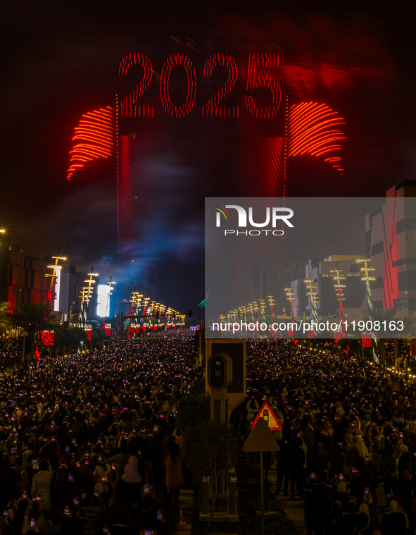 Fireworks and a drone show light up the midnight sky over Lusail Boulevard during the 2025 New Year's Day celebrations in Doha, Qatar, on Ja...