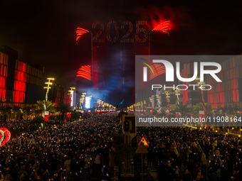 Fireworks and a drone show light up the midnight sky over Lusail Boulevard during the 2025 New Year's Day celebrations in Doha, Qatar, on Ja...