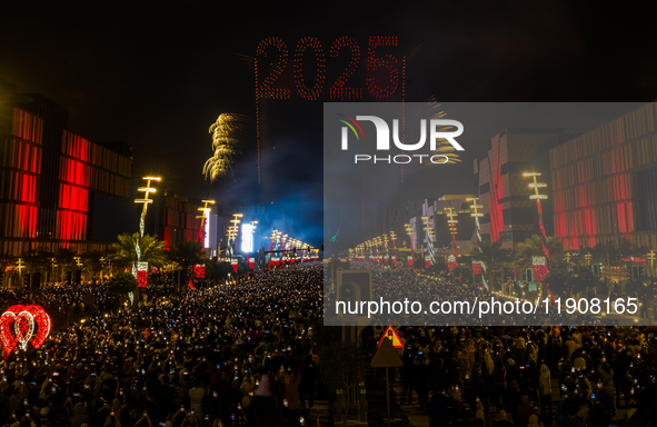 Fireworks and a drone show light up the midnight sky over Lusail Boulevard during the 2025 New Year's Day celebrations in Doha, Qatar, on Ja...