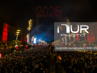 Fireworks and a drone show light up the midnight sky over Lusail Boulevard during the 2025 New Year's Day celebrations in Doha, Qatar, on Ja...