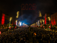 Fireworks and a drone show light up the midnight sky over Lusail Boulevard during the 2025 New Year's Day celebrations in Doha, Qatar, on Ja...