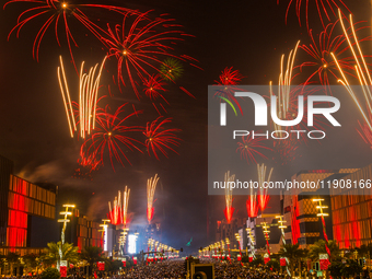 Fireworks and a drone show light up the midnight sky over Lusail Boulevard during the 2025 New Year's Day celebrations in Doha, Qatar, on Ja...