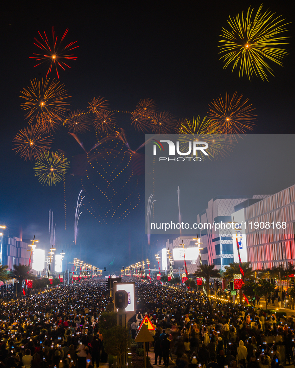 Fireworks and a drone show light up the midnight sky over Lusail Boulevard during the 2025 New Year's Day celebrations in Doha, Qatar, on Ja...