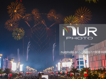 Fireworks and a drone show light up the midnight sky over Lusail Boulevard during the 2025 New Year's Day celebrations in Doha, Qatar, on Ja...