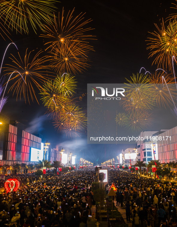 Fireworks and a drone show light up the midnight sky over Lusail Boulevard during the 2025 New Year's Day celebrations in Doha, Qatar, on Ja...