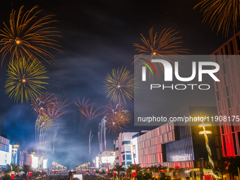 Fireworks and a drone show light up the midnight sky over Lusail Boulevard during the 2025 New Year's Day celebrations in Doha, Qatar, on Ja...