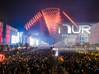 Fireworks and a drone show light up the midnight sky over Lusail Boulevard during the 2025 New Year's Day celebrations in Doha, Qatar, on Ja...