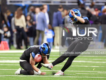 DETROIT,MICHIGAN-JANUARY 5:  Place kicker Jake Bates (39) of the Detroit Lions kicks the ball held by punter Jack Fox (3) of the Detroit Lio...