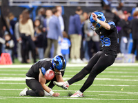 DETROIT,MICHIGAN-JANUARY 5:  Place kicker Jake Bates (39) of the Detroit Lions kicks the ball held by punter Jack Fox (3) of the Detroit Lio...