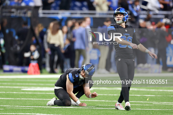 DETROIT,MICHIGAN-JANUARY 5: Place kicker Jake Bates (39) of the Detroit Lions follows his kick which was held by punter Jack Fox (3) of the...