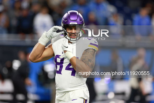 DETROIT,MICHIGAN-JANUARY 5:  Tight end Josh Oliver (84) of the Minnesota Vikings adjusts his helmet ahead of a game between the Detroit Lion...