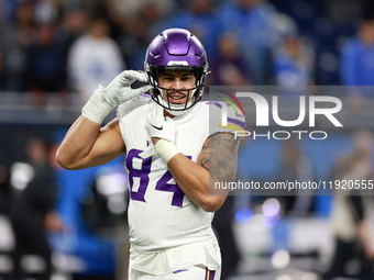 DETROIT,MICHIGAN-JANUARY 5:  Tight end Josh Oliver (84) of the Minnesota Vikings adjusts his helmet ahead of a game between the Detroit Lion...