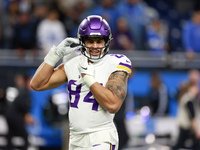 DETROIT,MICHIGAN-JANUARY 5:  Tight end Josh Oliver (84) of the Minnesota Vikings adjusts his helmet ahead of a game between the Detroit Lion...